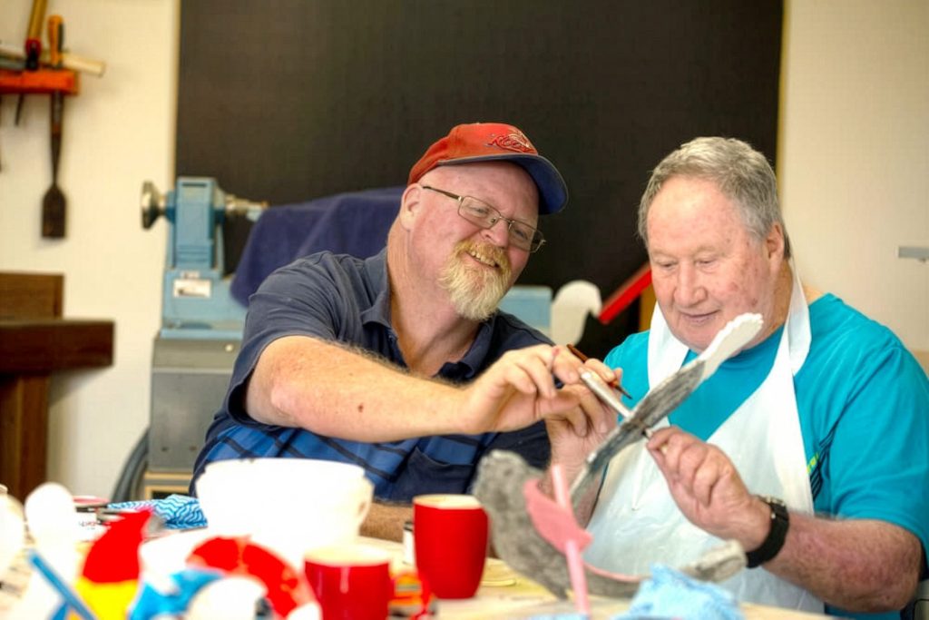 Two residents working on a craft activity together